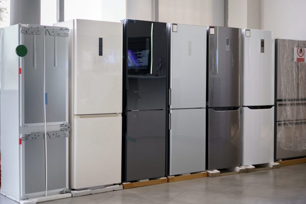Row of new fridges in household appliances store